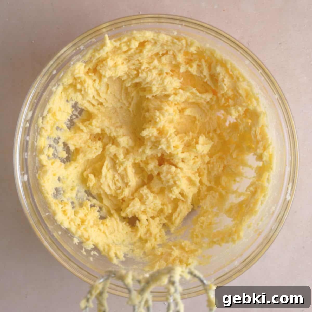 Softened butter, lemon sugar, egg yolk, lemon juice, and vanilla extract creamed together in bowl.
