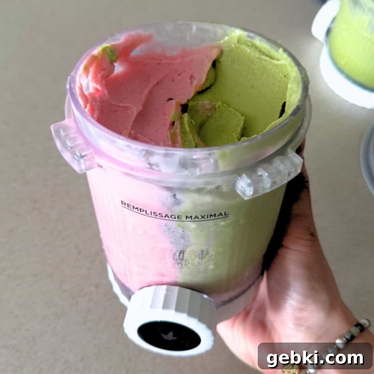 Strawberry Matcha Ninja Creami Treat 11 A Ninja Creami Swirl pint filled with half matcha and half strawberry ice cream.