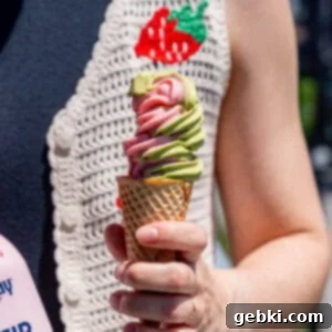 Strawberry Matcha Ninja Creami Treat 14 Kayla Burton holding strawberry matcha ice cream in a sugar cone.