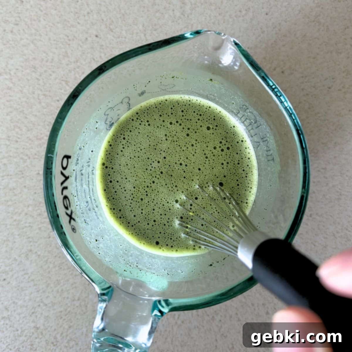 Strawberry Matcha Ninja Creami Treat 6 Whisking matcha powder and sugar into warm milk.