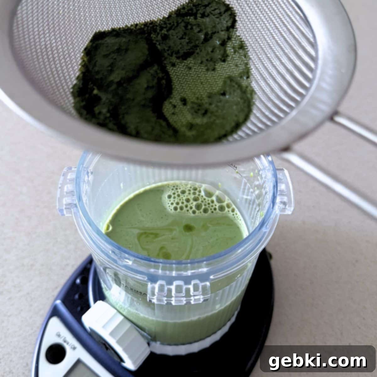 Strawberry Matcha Ninja Creami Treat 7 Straining a sweetened matcha milk mixture.