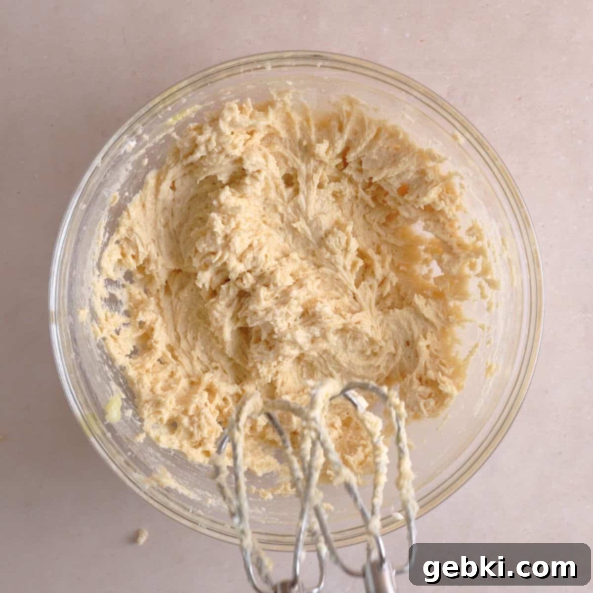 Irresistible Chewy Salted Caramel Oat Cookies 5 Butter, sugars, vanilla extract, and egg mixed in a bowl.