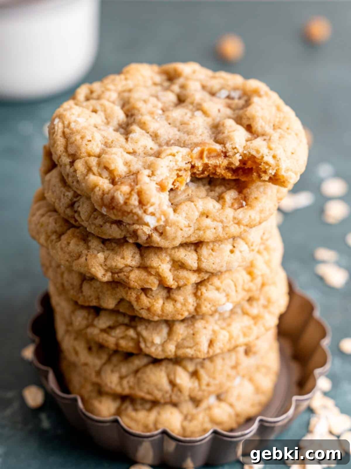 Irresistible Chewy Salted Caramel Oat Cookies 10 A stack of caramel oatmeal cookies with a bite taken out of one.