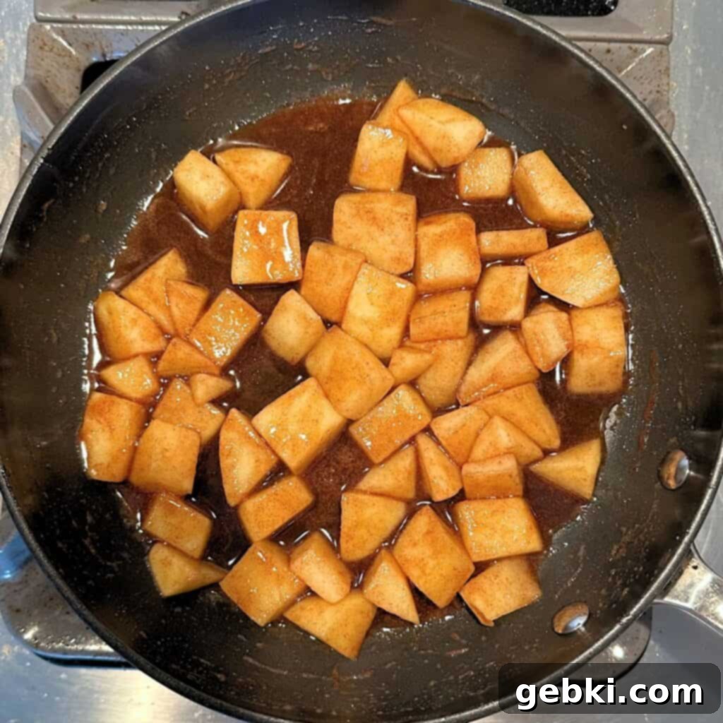 Ninja Creami Apple Pie Delight 6 Apples, butter, brown sugar, and cinnamon getting cooked in a skillet for the apple pie filling.