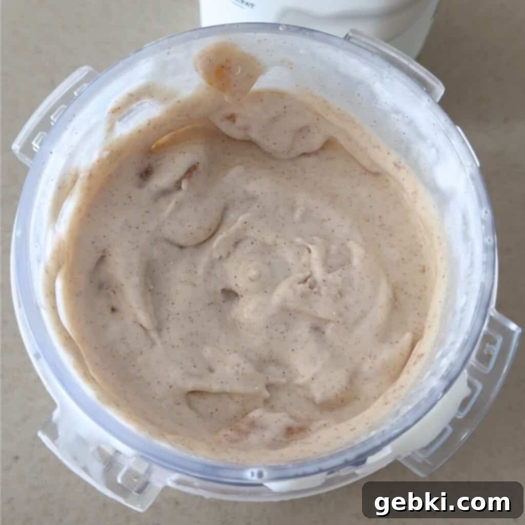 Ninja Creami Apple Pie Delight 7 Apple pie ice cream being mixed in a Ninja Creami pint.