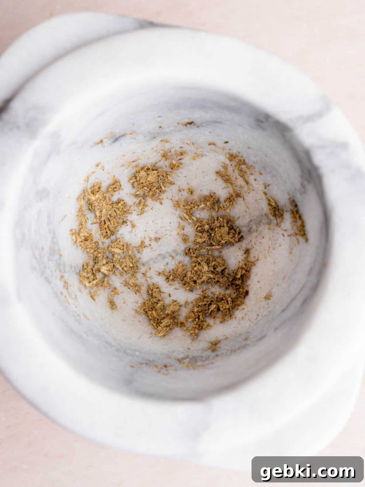 Dried lavender buds ground with a mortar and pestle.