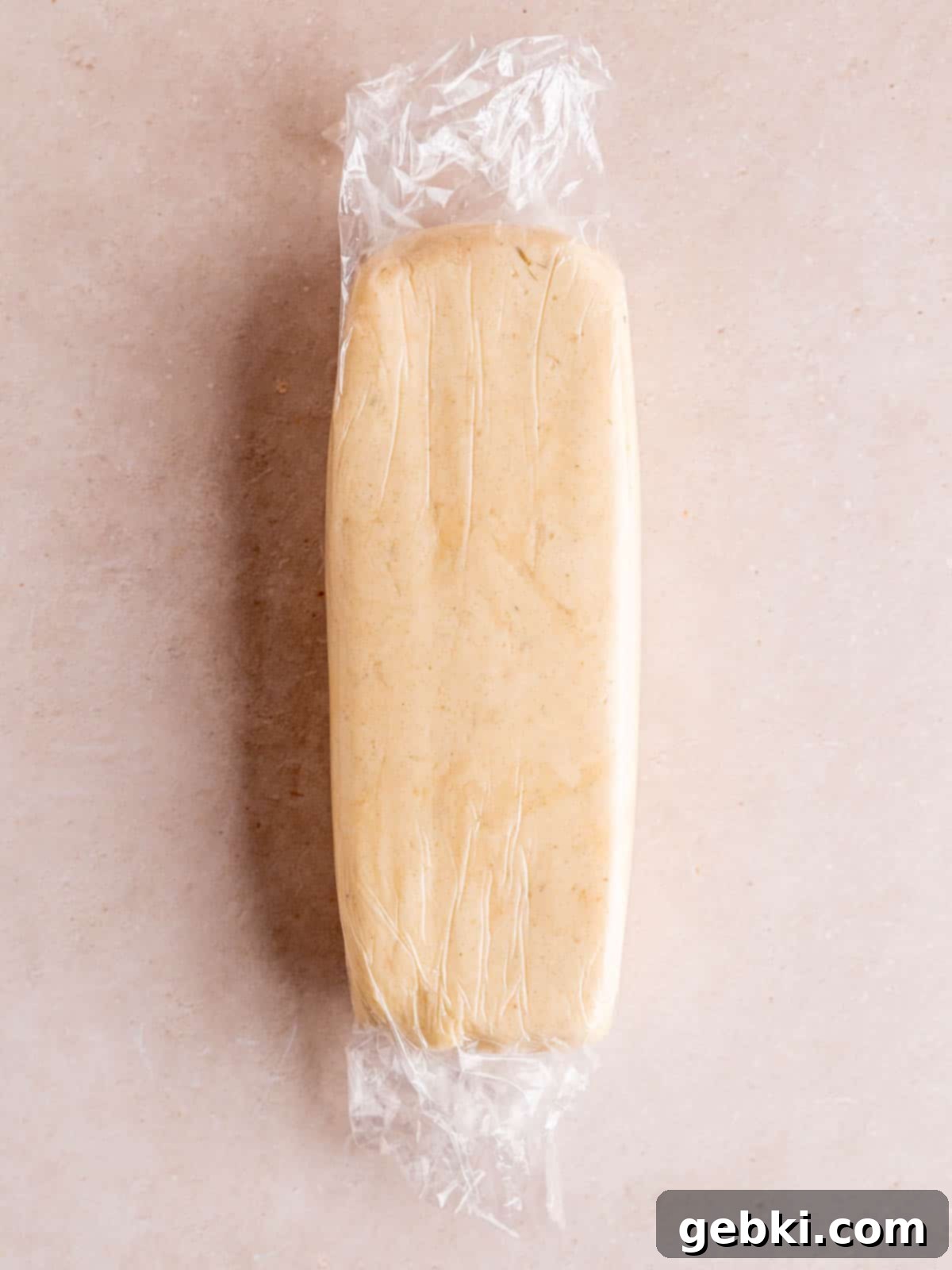 Lavender shortbread dough shaped into a rectangle and wrapped.