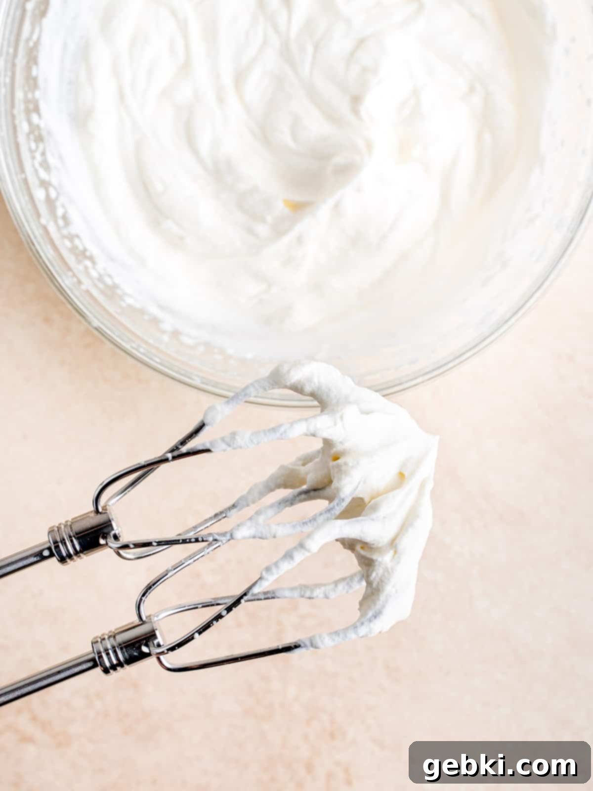 Cold heavy whipping cream whisked to stiff peaks with a hand mixer.