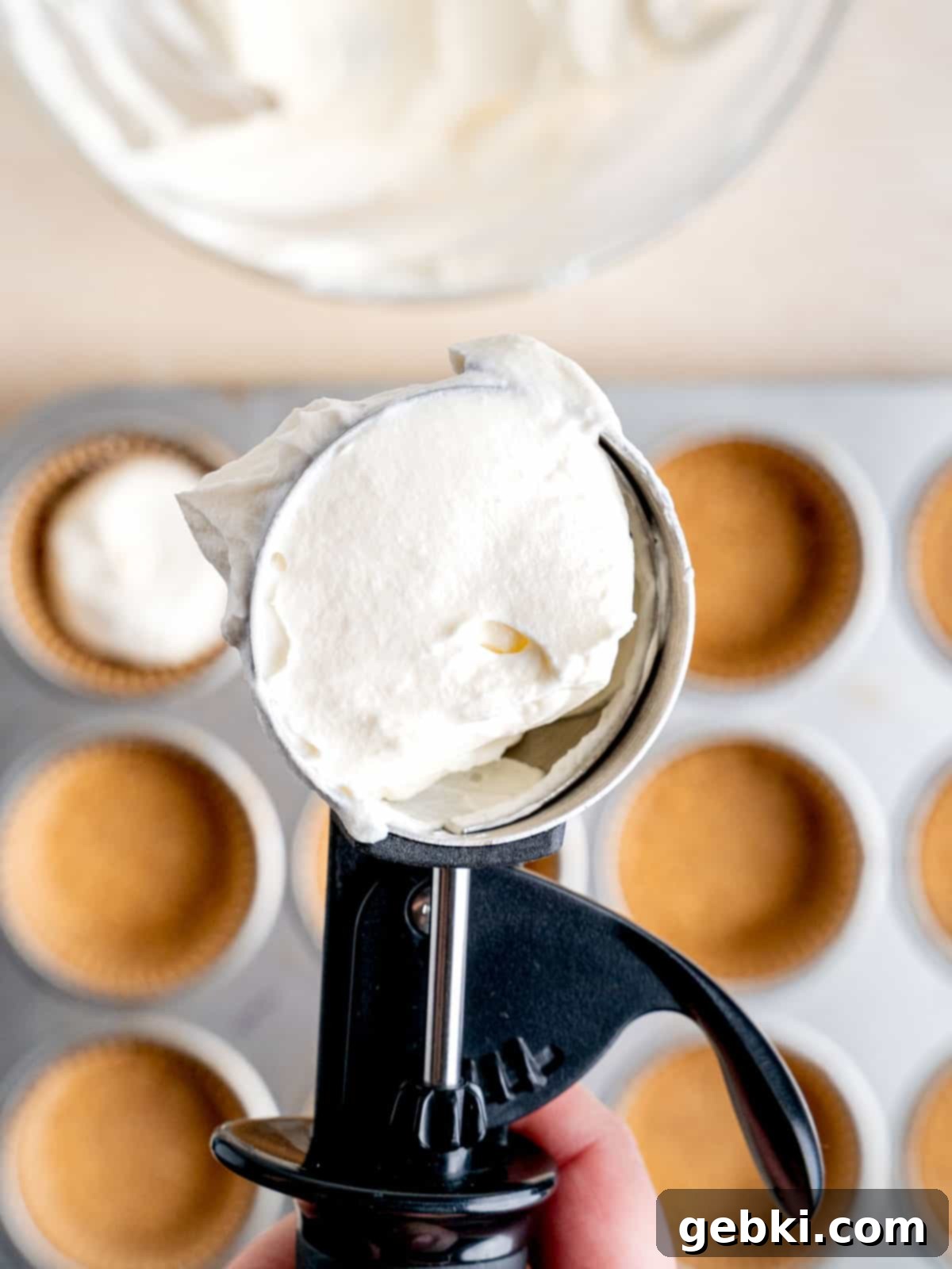 An ice cream scoop filled with no bake cheesecake filling.