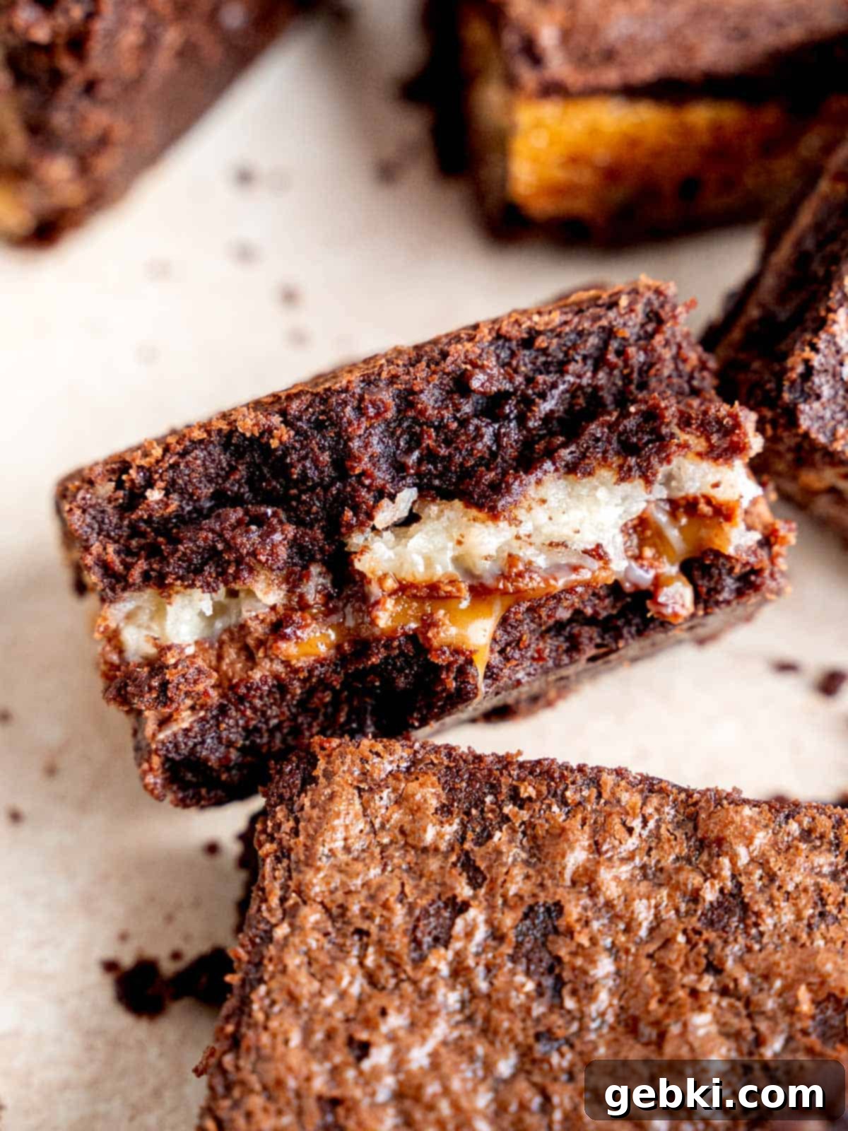 Samoa Caramel Coconut Brownies 2 Close up shot of a samoa brownie with a bite taken out of it, showing the coconut and caramel center.