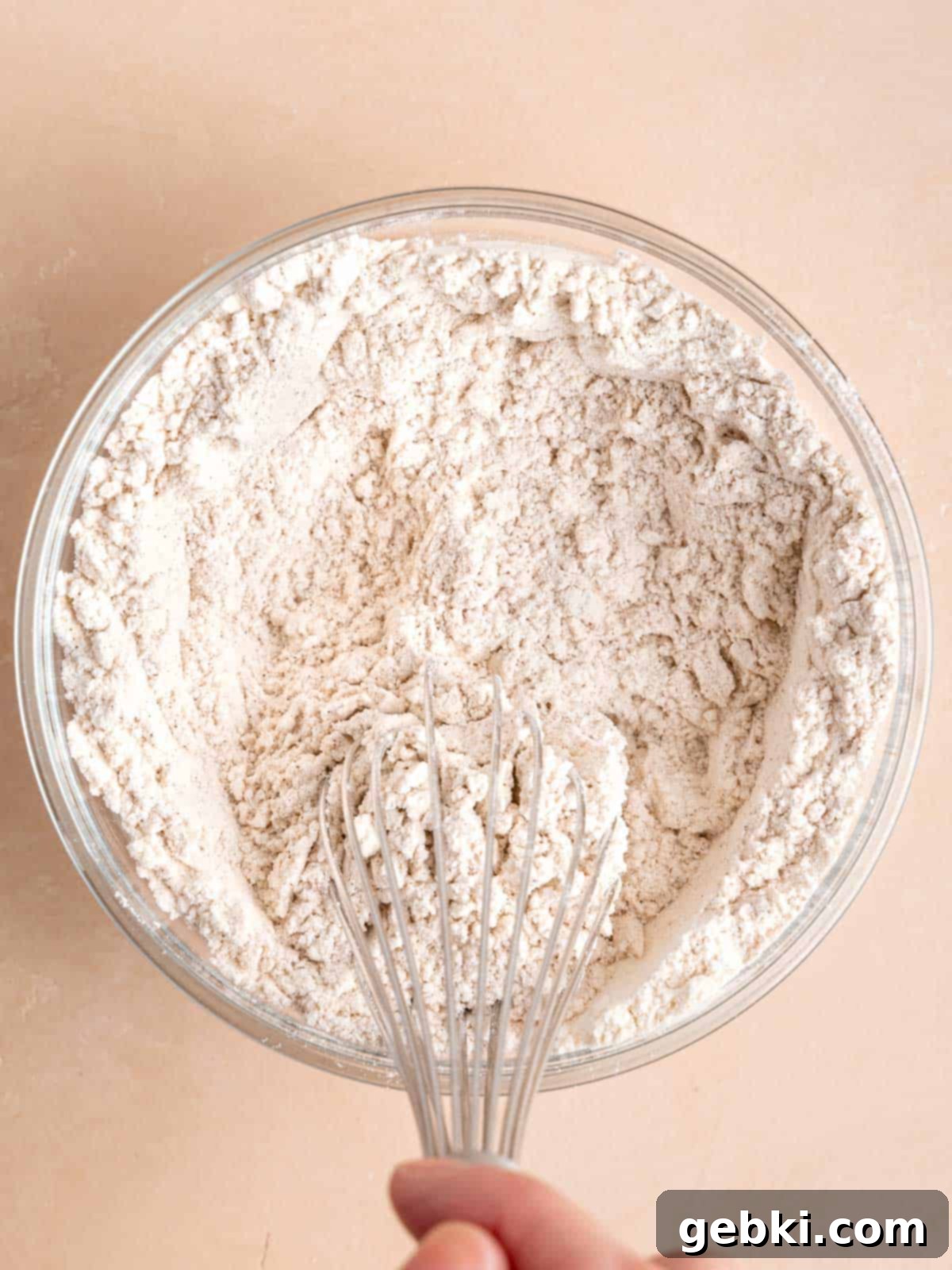 The Easiest Frosted Banana Cake Ever 4 Whisking flour, baking soda, salt, and cinnamon in a bowl.