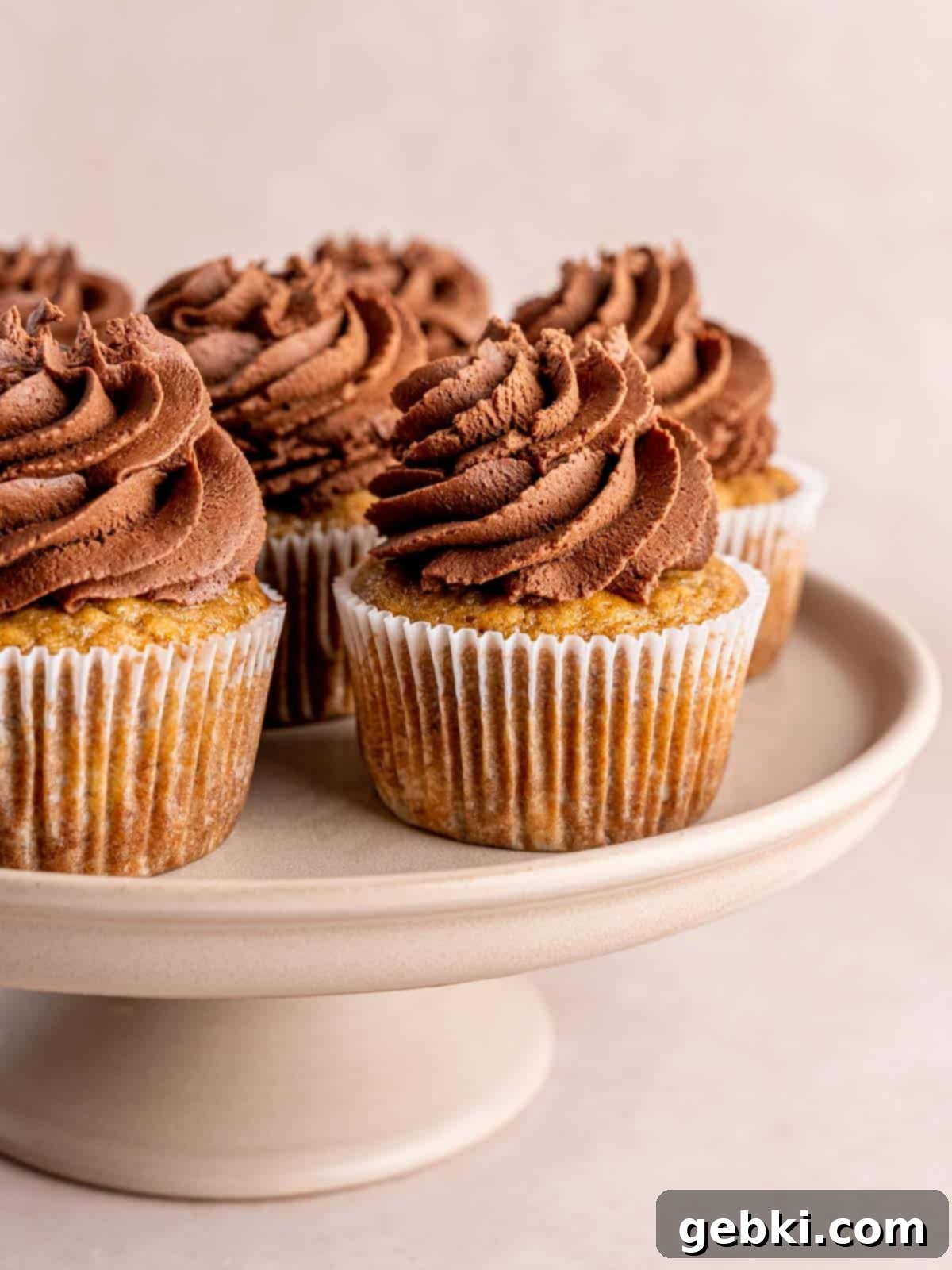 Banoffee Bliss Cupcakes 12 A display of beautifully frosted banoffee cupcakes on a elegant cake stand.