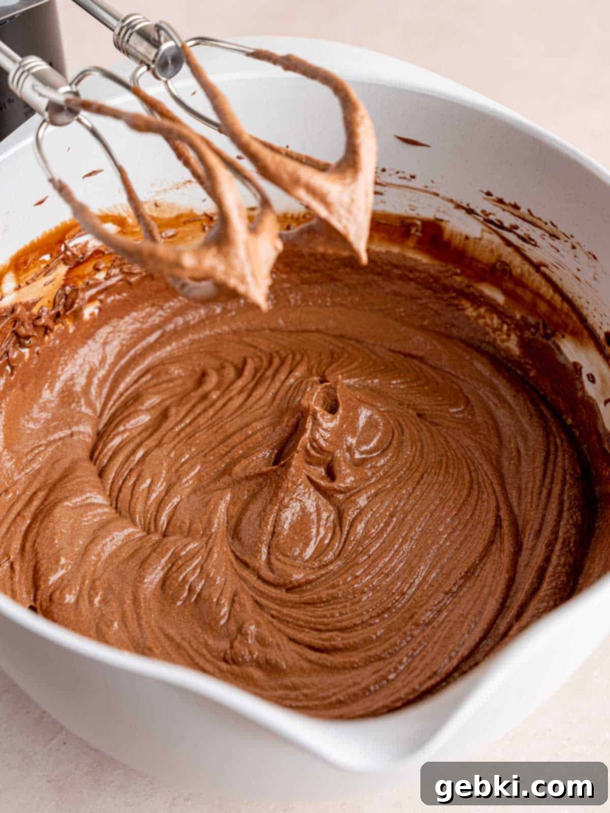 Banoffee Bliss Cupcakes 9 Whipped chocolate ganache with stiff peaks in a mixing bowl, ready for piping.