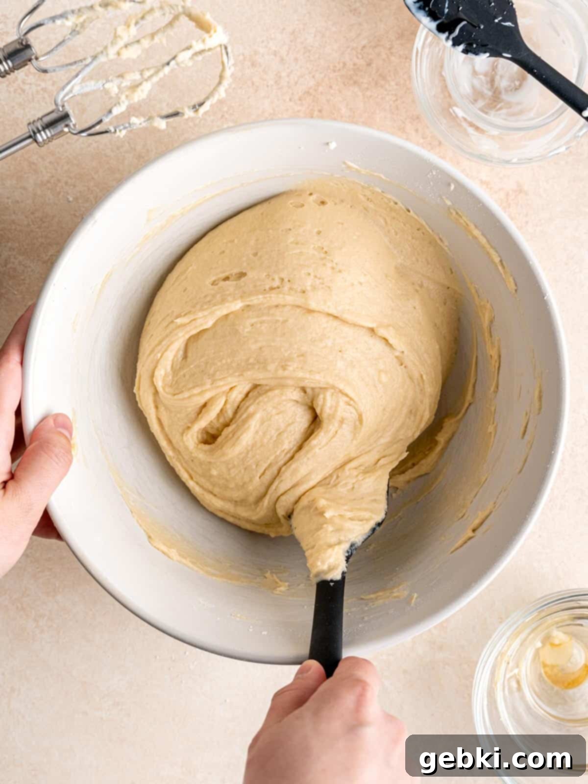 Effortless Honey Vanilla Delight 6 Folding honey-flavored vanilla cake batter in a bowl, showing the consistency of the mixture.