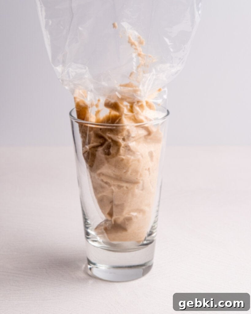 Meringue and dry ingredients being prepared for macaronage.