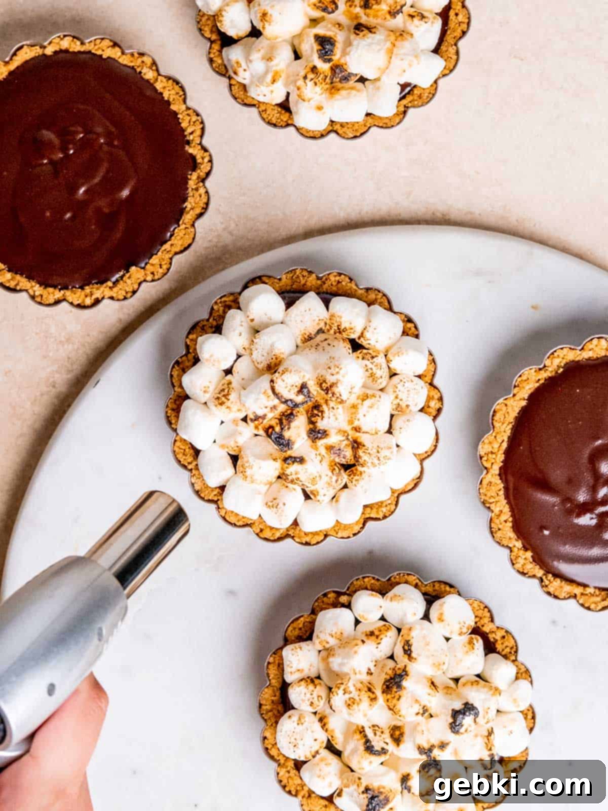 Peanut Butter S'mores Bites 5 Toasting mini marshmallows with a torch.
