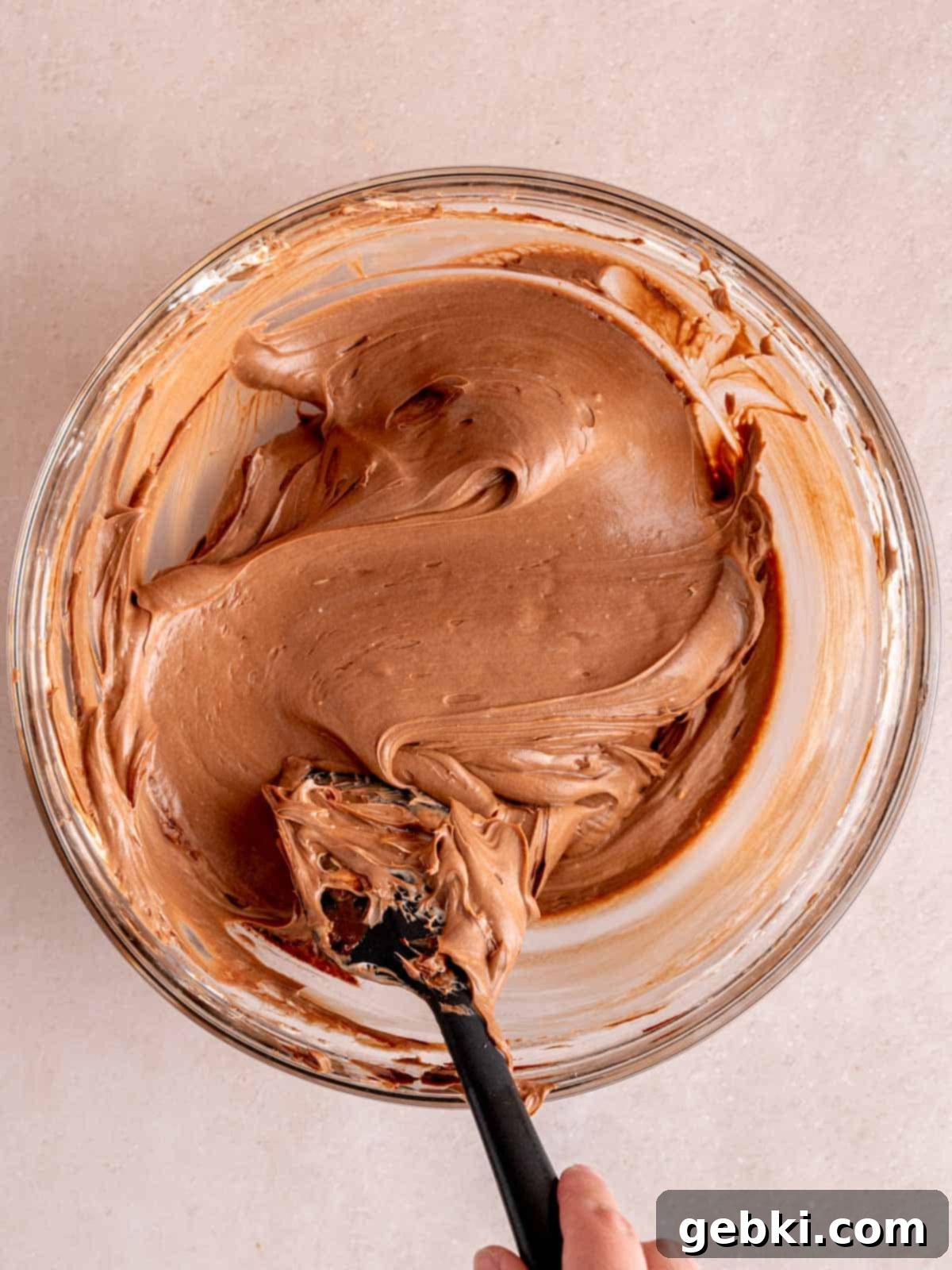 No-Bake Chocolate Cherry Cheesecake 10 Folding chocolate ganache into no bake cheesecake filling with a spatula.