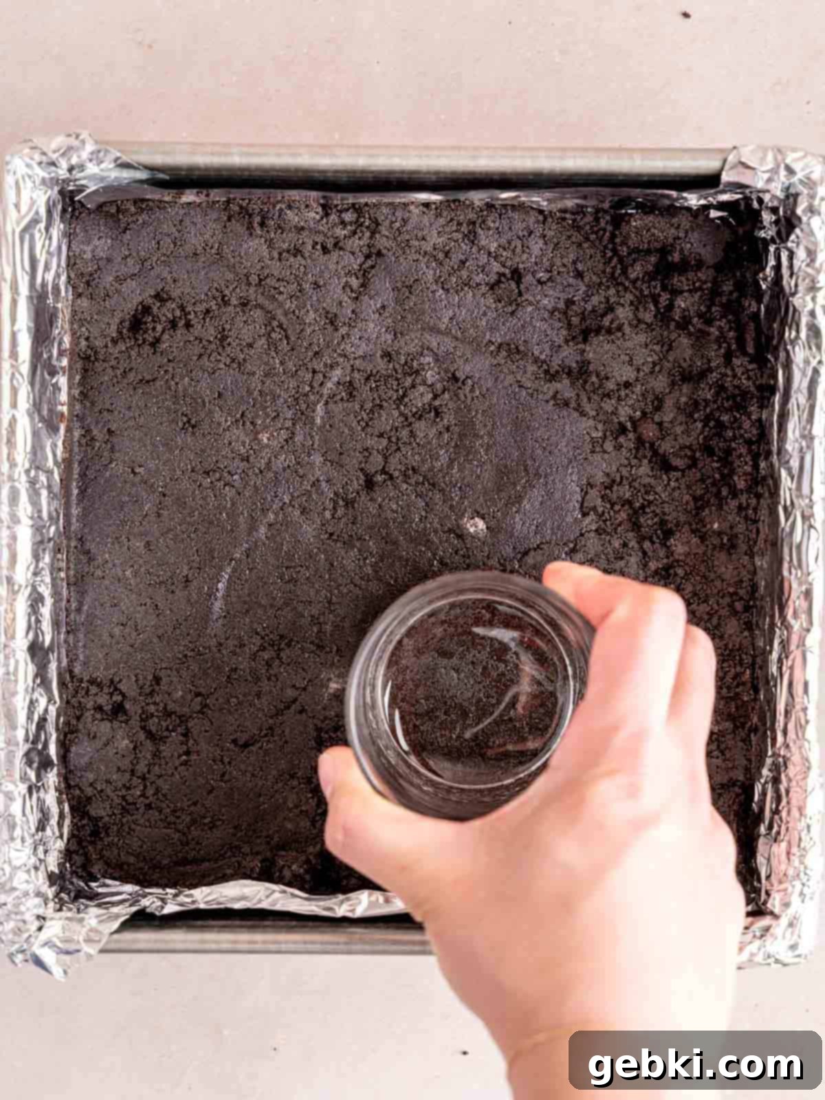 No-Bake Chocolate Cherry Cheesecake 4 Pressing Oreo crumbs into the bottom of an 8x8 inch pan.