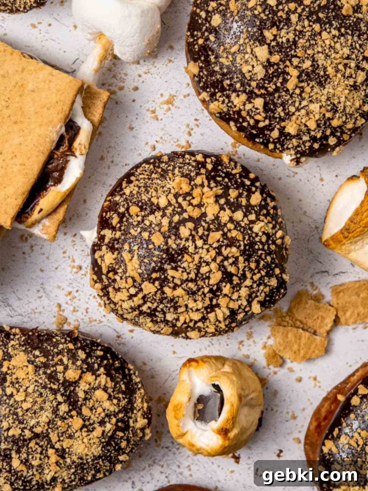 Gooey S'mores Stuffed Donuts 8 Top view of several S'mores donuts generously dipped in chocolate ganache and sprinkled with graham cracker crumbs, ready to be enjoyed.