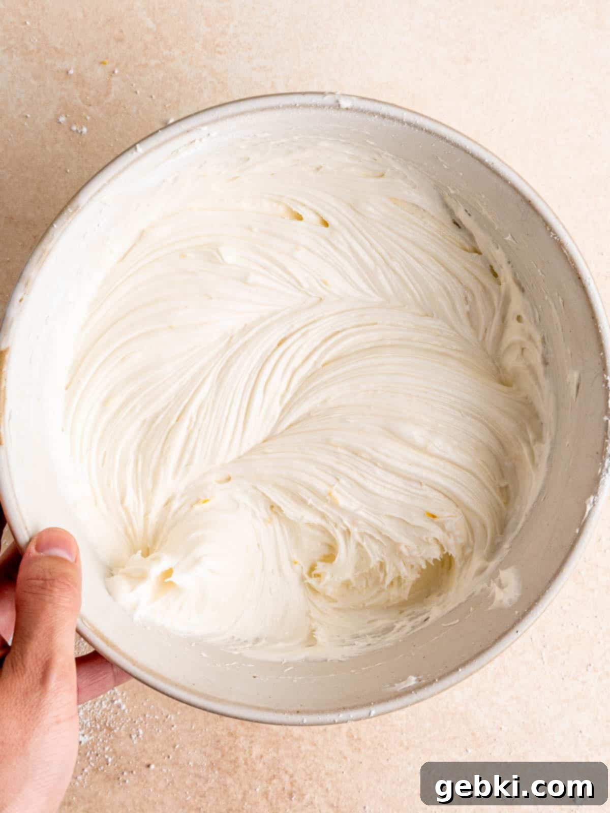 Lemon cream cheese frosting mixed in a bowl.