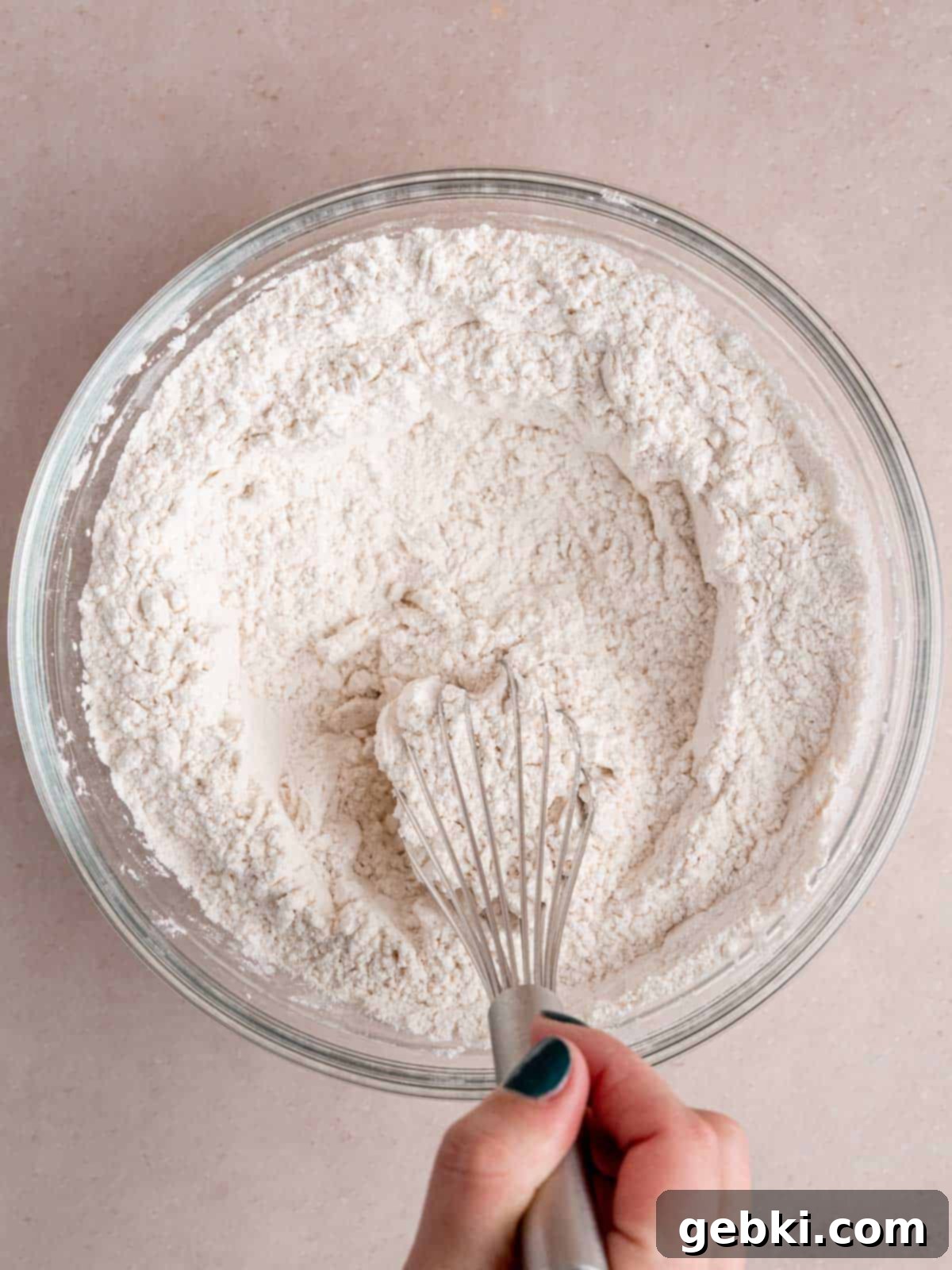Irresistible Lemon Raspberry Muffins 3 Whisking flour, baking powder, and salt together in a dry mixing bowl to combine dry ingredients.