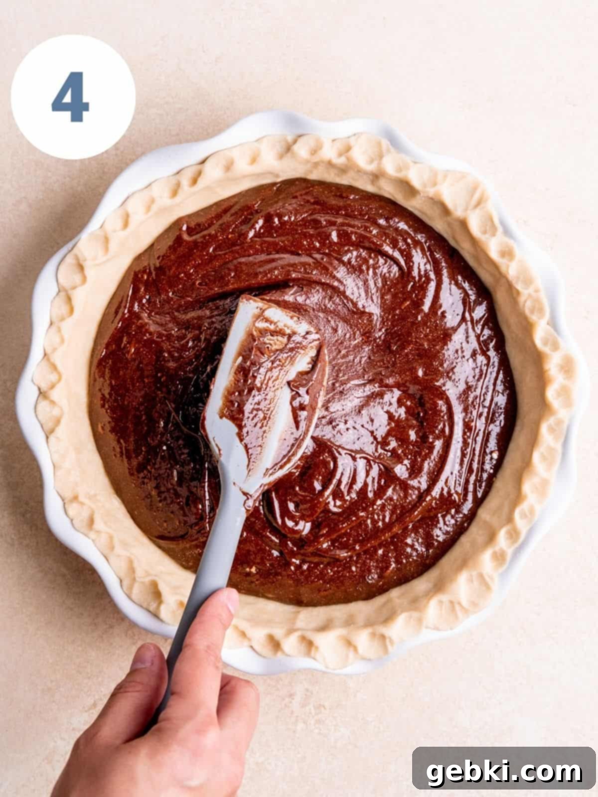 Fudgy Pecan Brownie Pie 7 Step 4: Spreading the brownie batter into the pie crust.