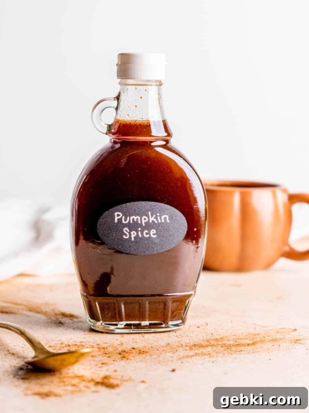A syrup bottle filled with homemade pumpkin spice syrup, labeled 