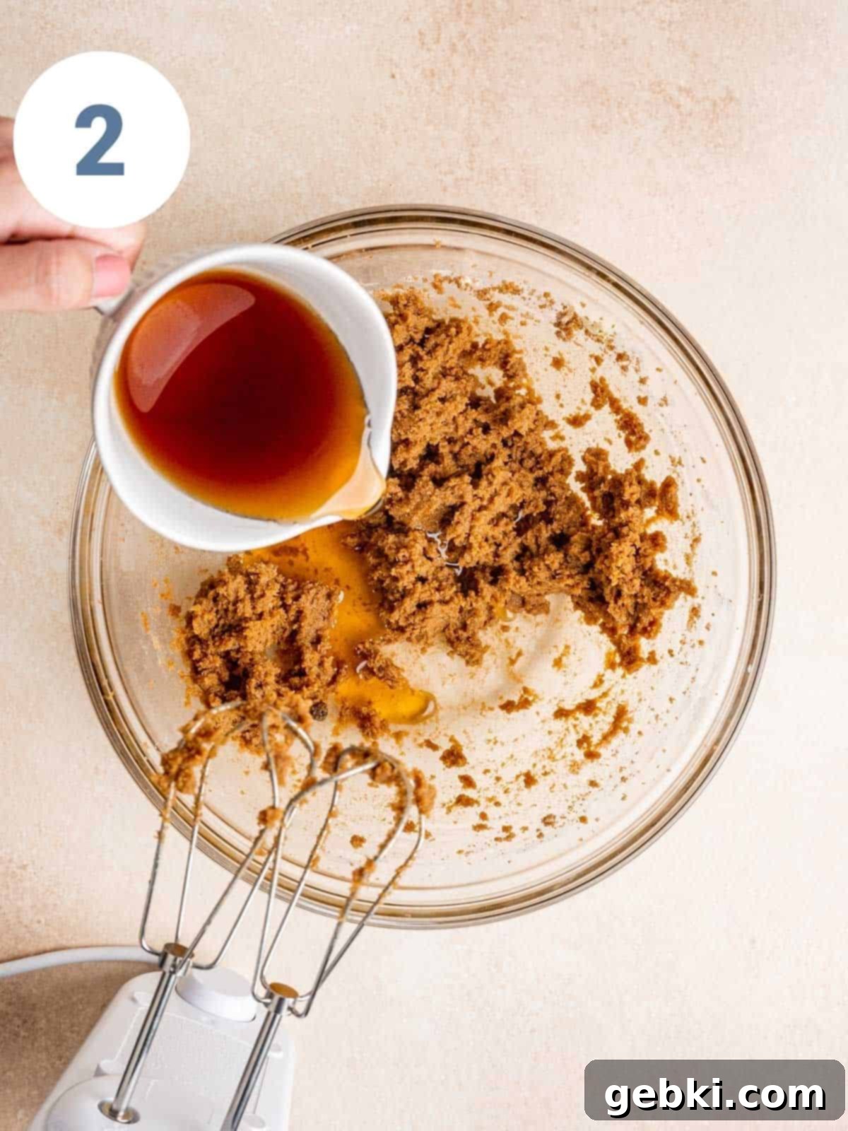 Pouring maple syrup into cookie dough.