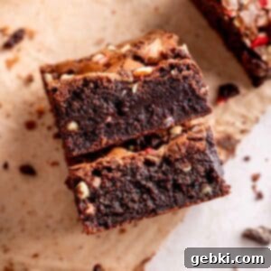 Two fudgy Andes mint brownies with their characteristic crackly tops and melted mint centers.