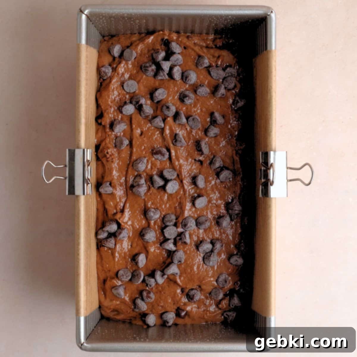 Decadent Double Chocolate Loaf 8 A prepared 9x5-inch loaf pan lined with parchment paper, filled with the smooth chocolate cake batter, topped generously with semi-sweet chocolate chips.