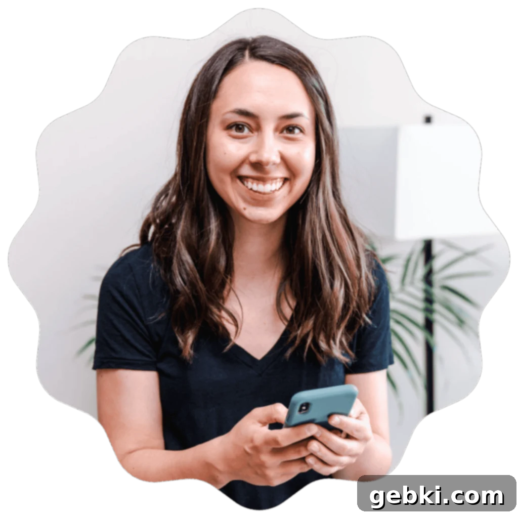 Effortless Pumpkin Oatmeal Muffins with Perfect Crumbly Streusel 13 Kayla Burton, the author from Broken Oven Baking Company, smiling and holding a smartphone, inviting readers to engage.