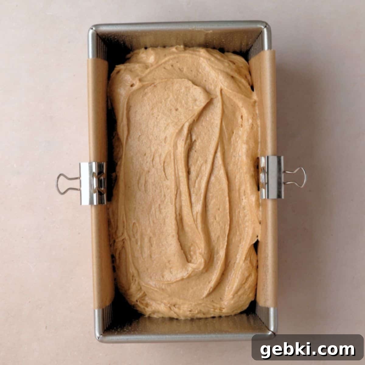 Simple Spiced Cake with Decadent Brown Butter Cream Cheese Frosting 8 Spice cake batter poured into loaf pan with parchment paper in it.