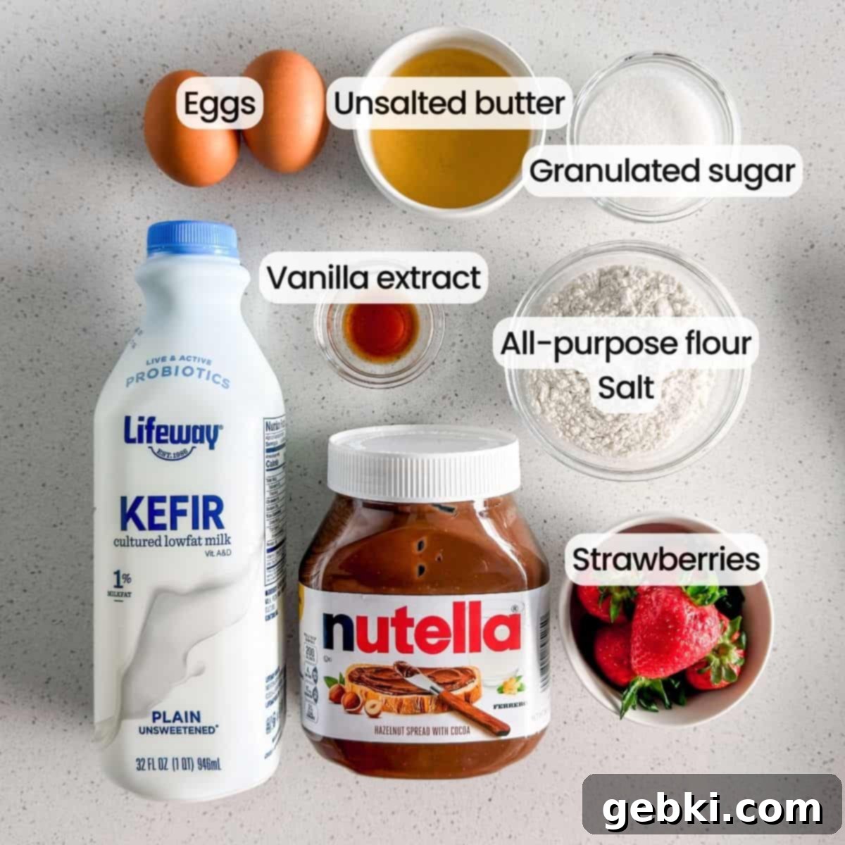 Strawberry Nutella Dream Crepes 3 A vibrant display of ingredients needed to make crepes with Nutella and strawberries, including kefir, eggs, flour, and fresh strawberries.