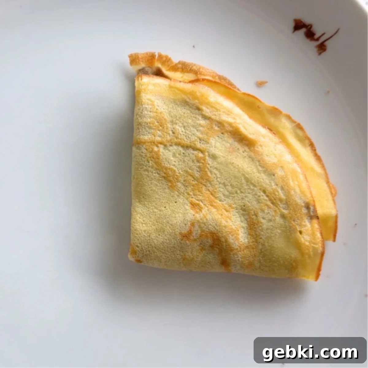 Strawberry Nutella Dream Crepes 9 A Nutella and strawberry filled crepe neatly folded into quarters.