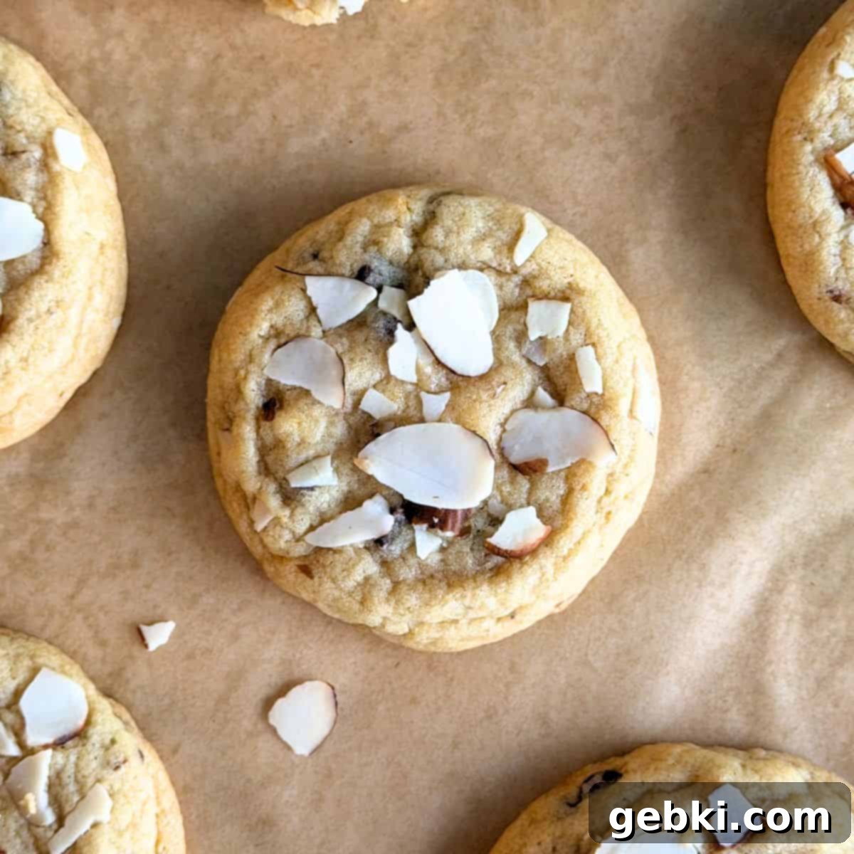 Finished orange almond chocolate chip cookie, showcasing its slightly tanned edges and soft center.
