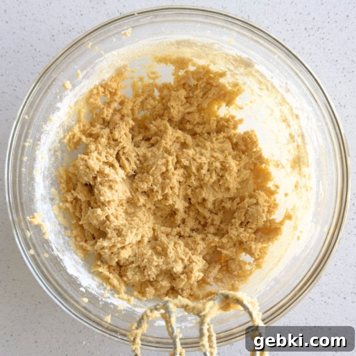 Dry ingredients being mixed into the wet ingredients to form the cookie dough.